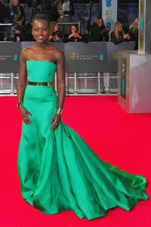 Lupita Nyongo green satin red carpet dress at 2014 BAFTA