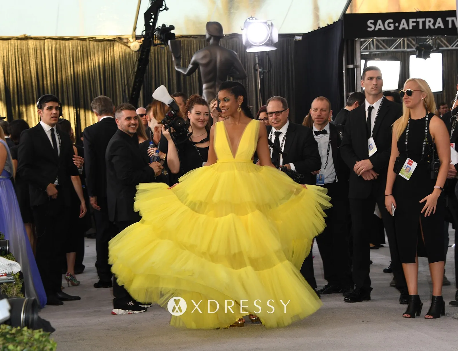 Susan Kelechi Watson yellow tiered tulle gown with plunging v neck at the 2019 SAG Awards