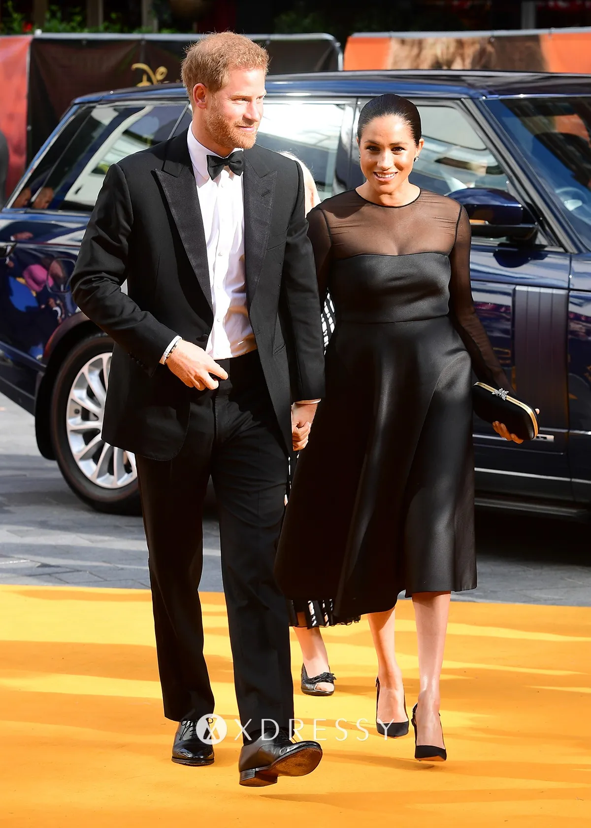 Meghan Markle looked elegant in a mesh panel little black satin dress at the European premiere of The Lion King Meghan Markle looked elegant in a mesh panel little black satin dress at the European premiere of The Lion King