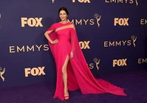 Catherine Zeta Jones caught admiring stares in a hot pink caped dress with an illusion panel at the 2019 Emmy Awards