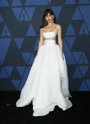 Dakota Johnson in a two piece ruched white satin gown with shoulder straps at Governors Awards 2019