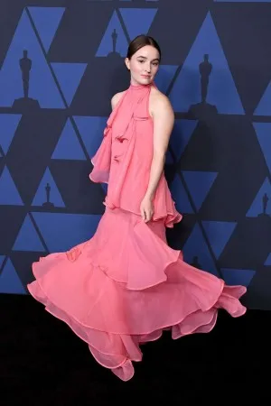 Kaitlyn Dever at 2019 Governors Awards in a watermelon chiffon low back ruffled halter celebrity long party dress