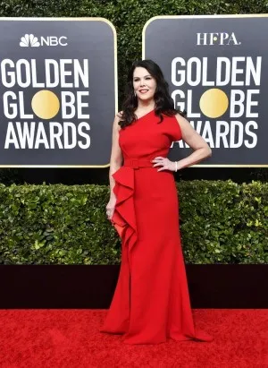 Lauren Graham in a ruffled red one shoulder formal gown with a thigh high slit for the red carpet of 2020 Golden Globes