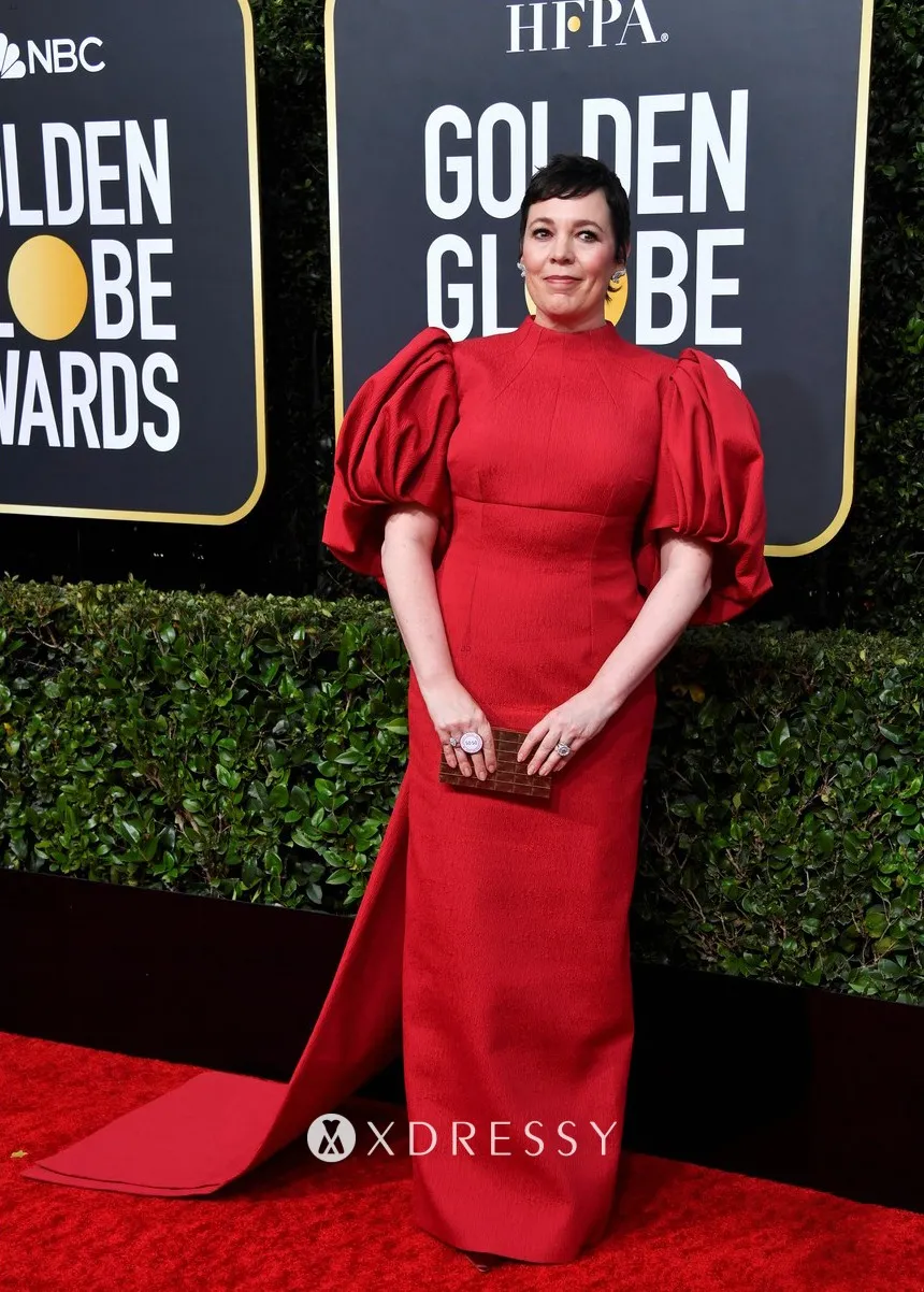 Olivia Colman glammed up in a dark red satin column evening dress with balloon sleeves and a long train