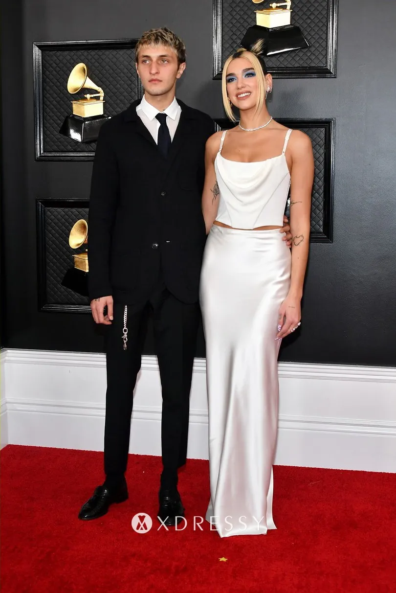 Dua Lipa looked alluring in a sexy white two pieces sheath long evening gown with thin shoulder straps Dua Lipa looked alluring in a sexy white two pieces sheath long evening gown with thin shoulder straps