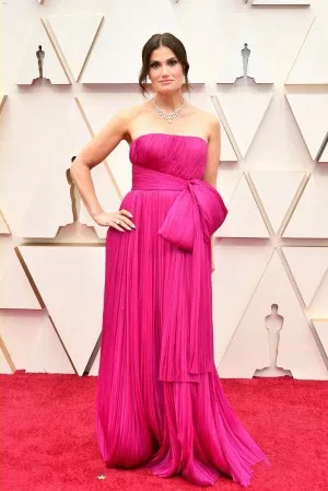 Idina Menzel in a strapless pleated long fuchsia formal gown with oversized bow detailing at the 2020 Oscars red carpet