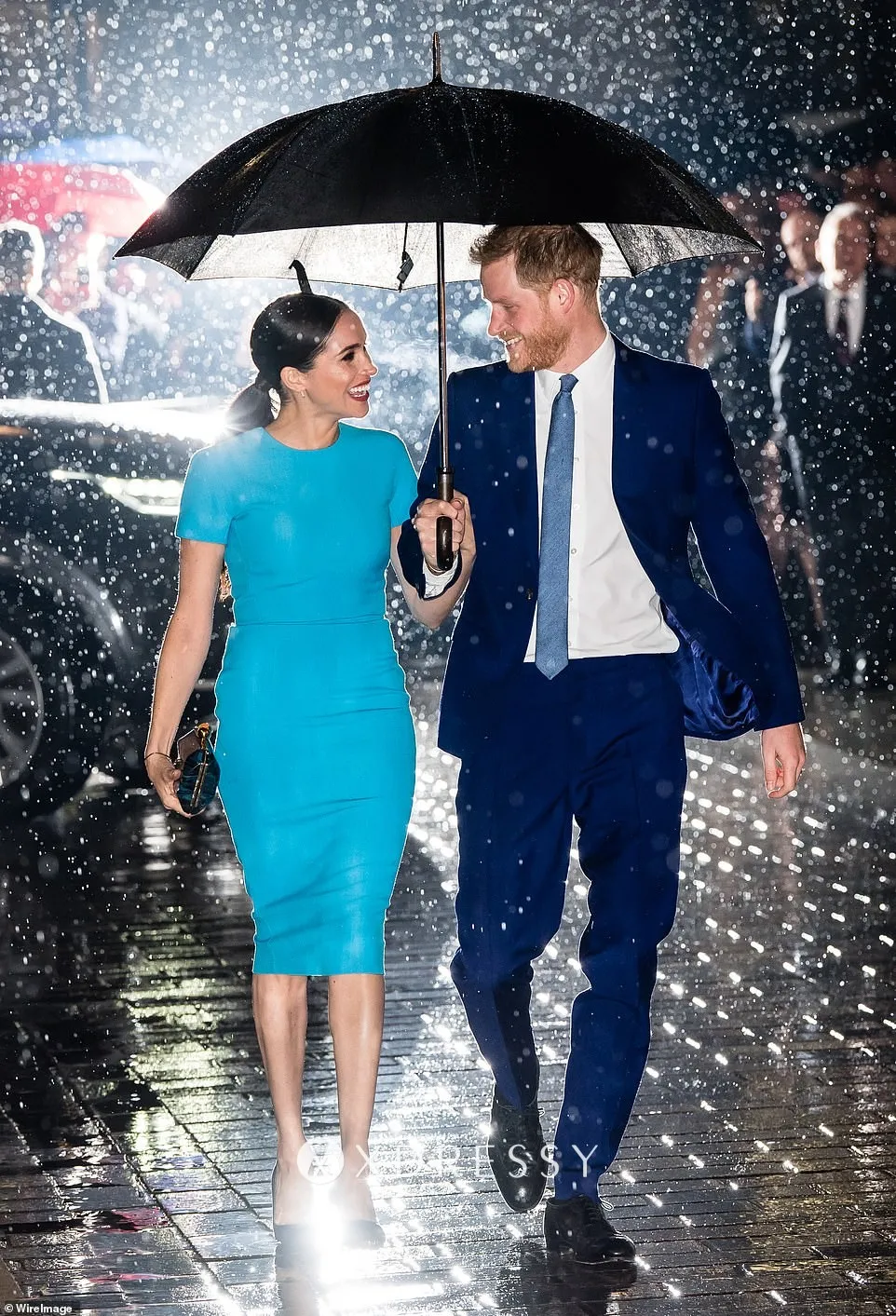 Meghan Markle wears a blue sheath midi dress with short sleeves at the 2020 Endeavor Fund Awards