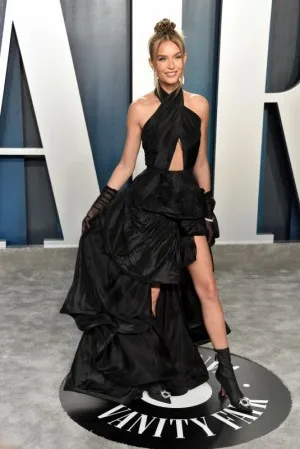 Josephine Skriver looked flirty in a draped black high low cut out prom dress at the 2020 Vanity Fair Oscar party