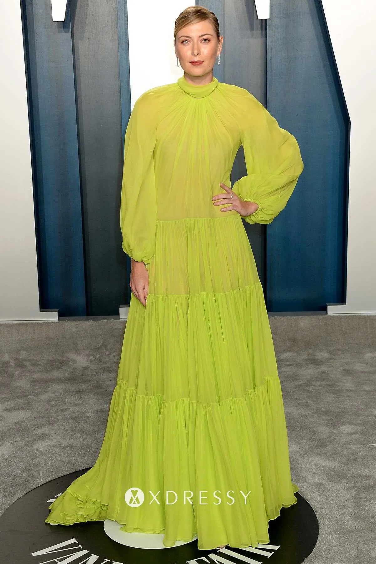 Maria Sharapova attends Vanity Fair Oscar Party 2020 featuring a see through lemon green chiffon evening dress