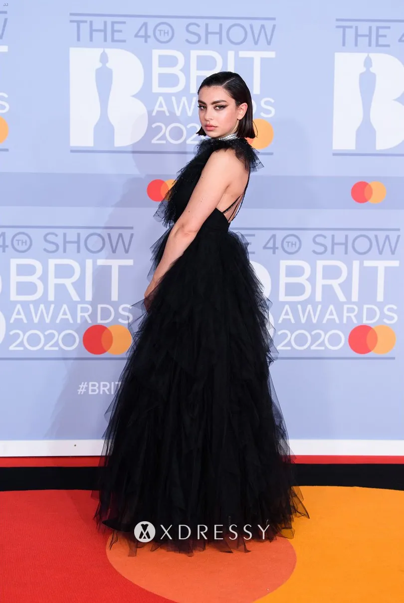 Charli XCX in a princess black tulle cap sleeve A line long evening dress featuring low back at the 2020 BRIT Awards