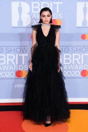 Charli XCX was a goth princess in a black tulle evening dress featuring a V neckline at the 2020 BRIT Awards red carpet