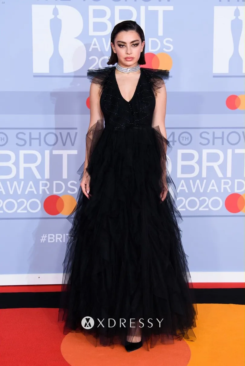 Charli XCX was a goth princess in a black tulle evening dress featuring a V neckline at the 2020 BRIT Awards red carpet