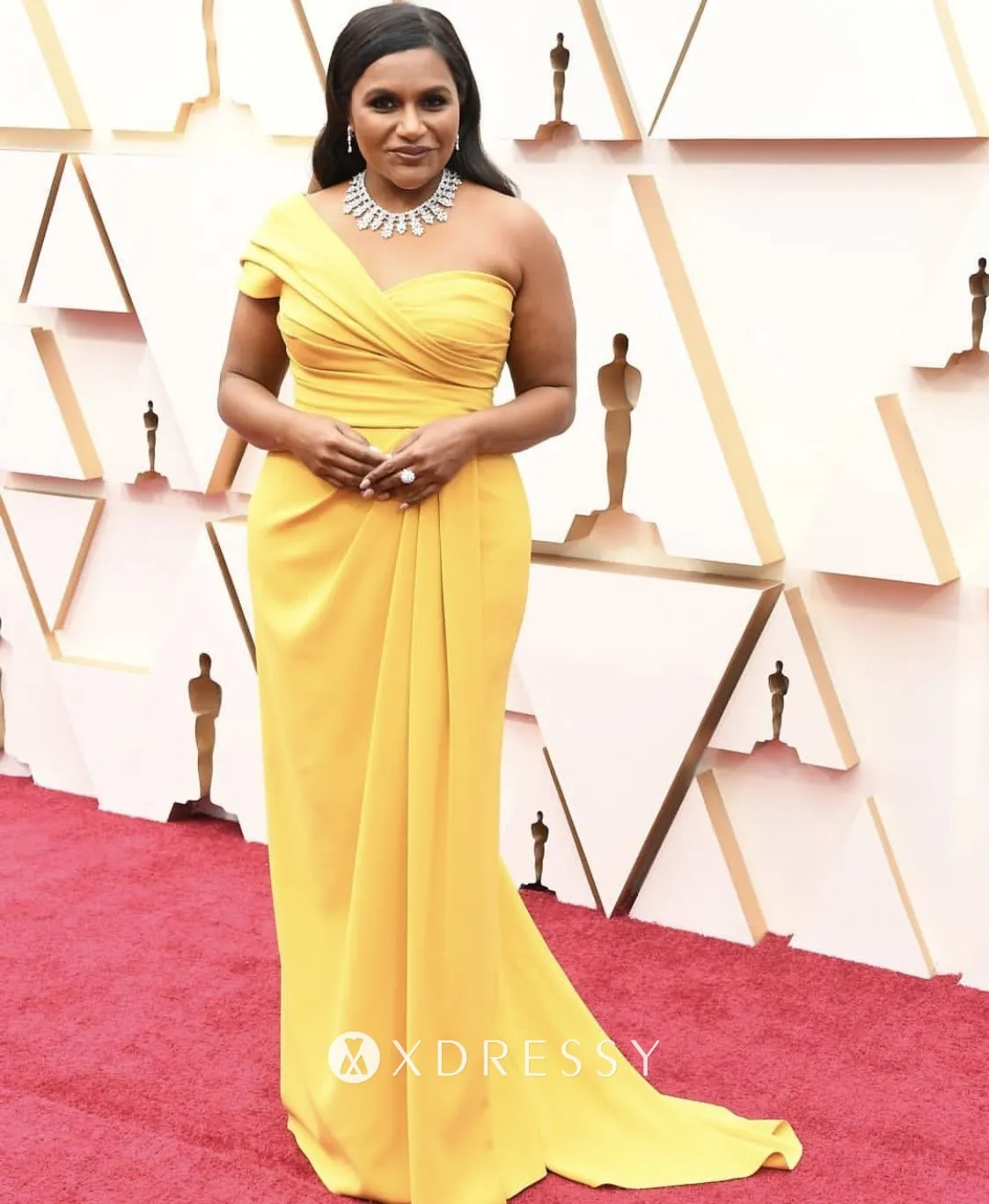 Mindy Kaling was bright and elegant in a yellow one shoulder evening prom formal gown at the 2020 Oscars red carpet