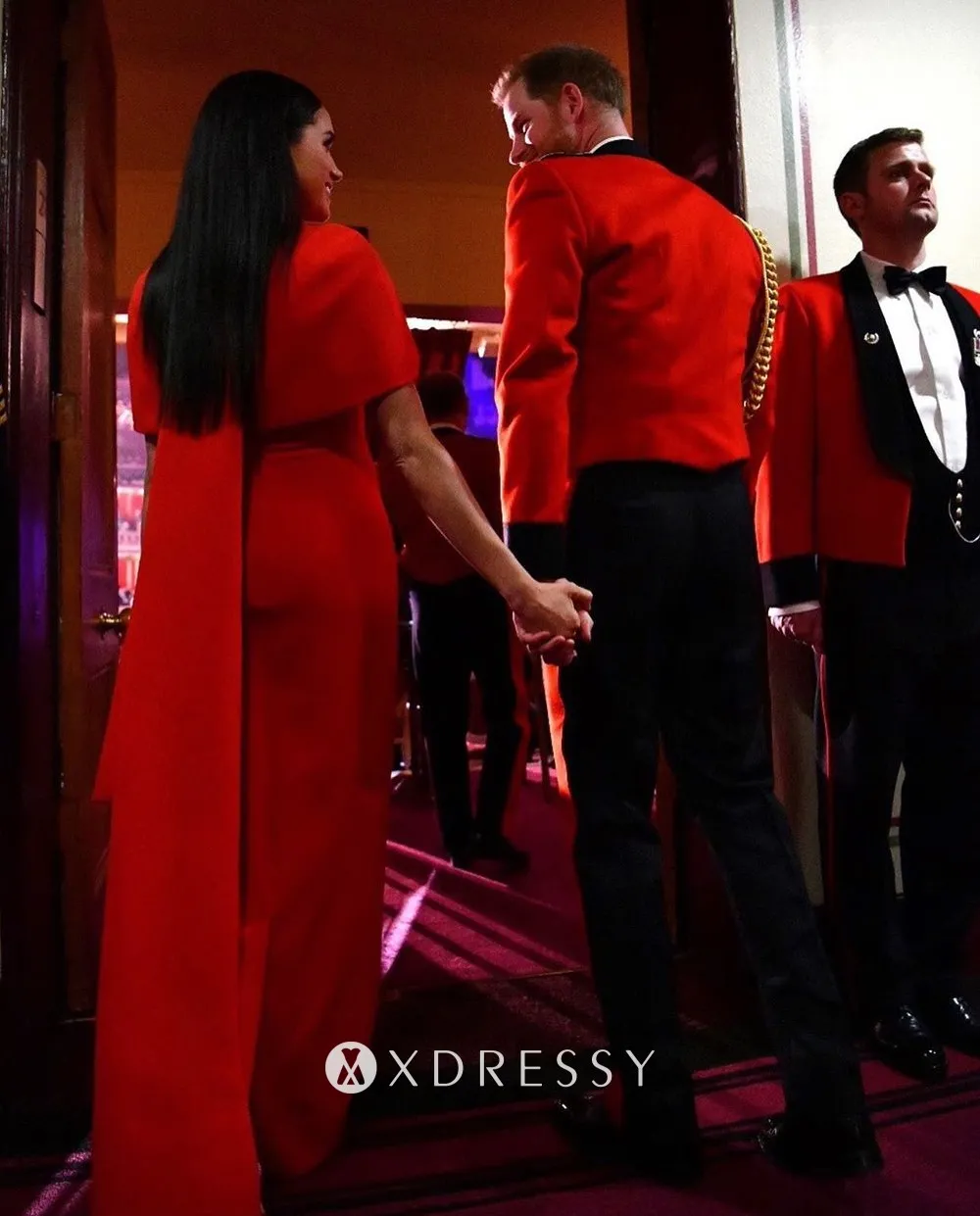 Meghan Markle in a scarlet dress with capelet detailing at the Mountbatten Music Festival 2020
