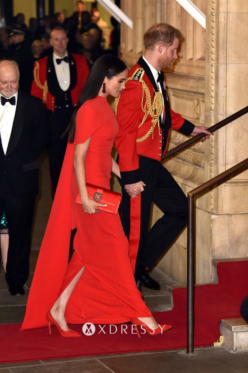 Meghan Markle looked downright regal in a scarlet dress with capelet detailing at the Mountbatten Music Festival 2020