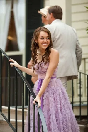 Miley Cyrus was in this ruffled lavender purple tulle celebrity tea length dress which is from the The Last Song