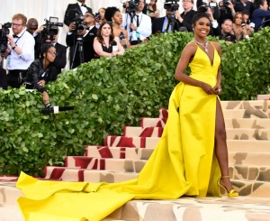 Gabrielle Union bright yellow prom gown with long train at the Met Gala 2018