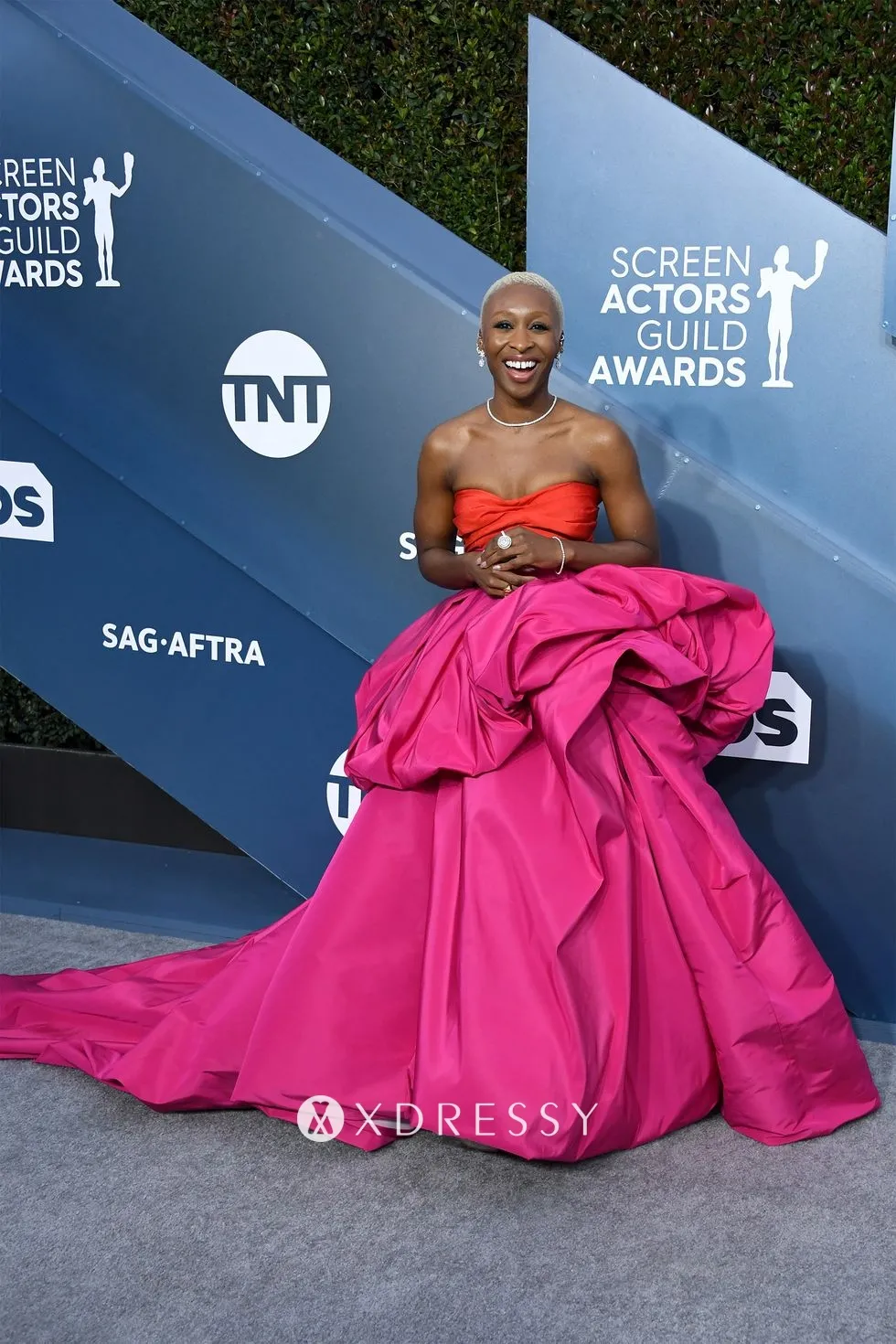 Cynthia Erivo strapless orange and fuchsia draped prom ball gown