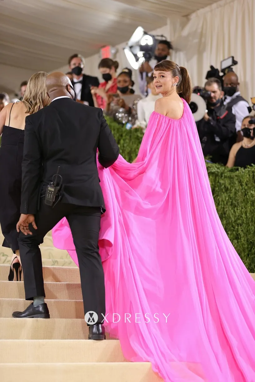 Carey Mulligan vibrant fuchsia dress with matching cape