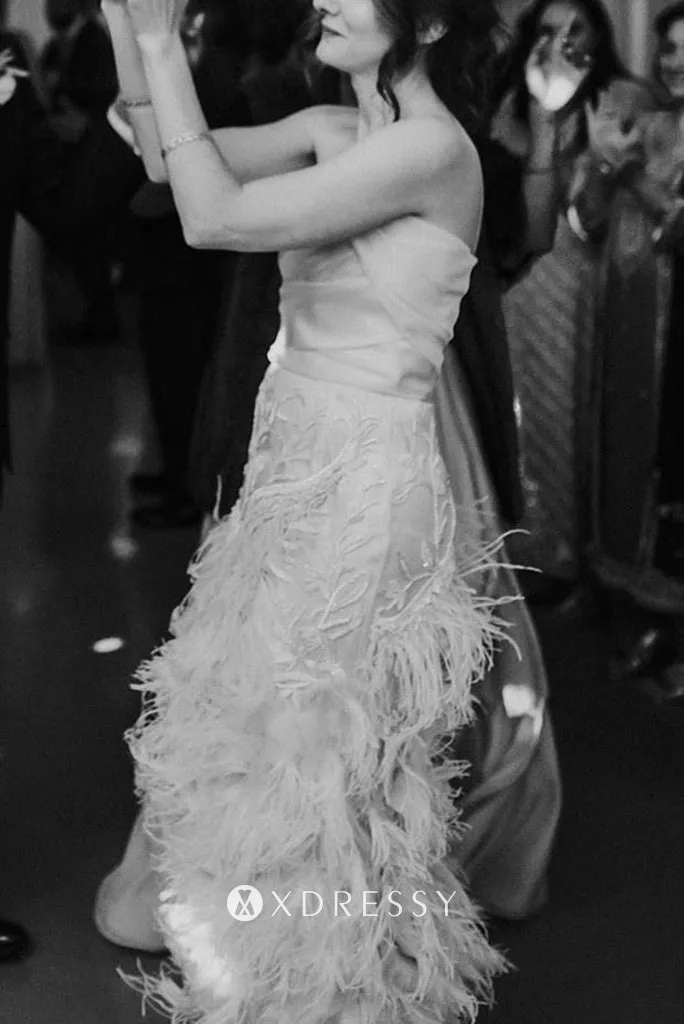 Beautiful draped ivory satin faced organza sheath long bridal dress with ostrich feather cascading down skirt Beautiful draped ivory satin faced organza sheath long bridal dress with ostrich feather cascading down skirt